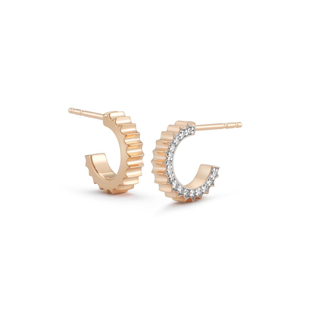 Rose gold hoop earrings with gear type sculpting on the front and diamonds on the side.