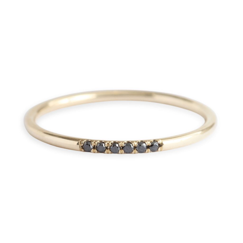 Yellow gold band with six small black diamonds.