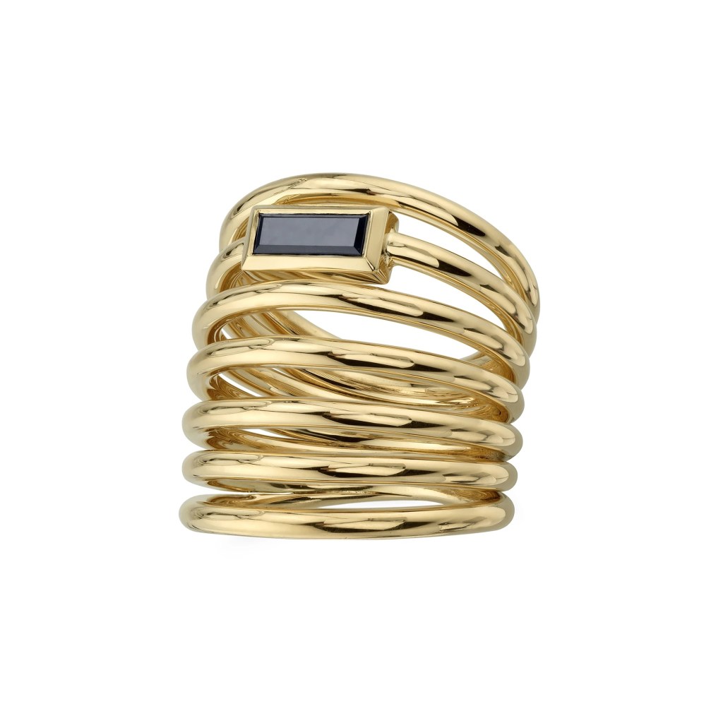 Yellow gold multi row band with an offset large black diamond in baguette shape.
