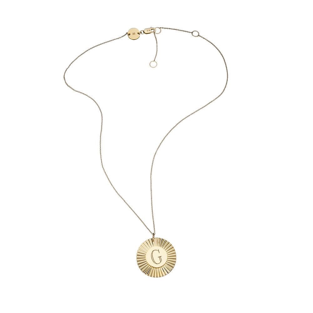 Medallion style yellow gold necklace with engraved letter G in the centre and bevelled rim on the outside.
