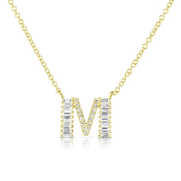 Letter M necklace in yellow gold studded with white round and baguette cut diamonds.